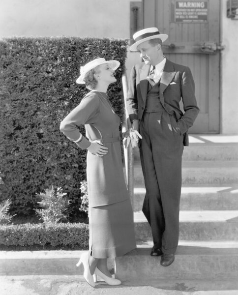 Elegant couple standing together and looking at each other