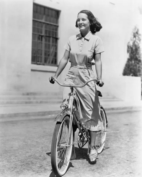 Jonge vrouw haar fiets rijden — Stockfoto
