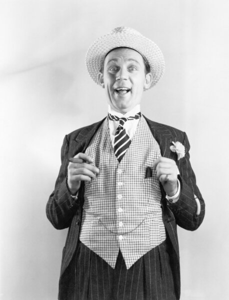 Man in a vest looking happy and proud