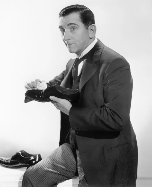 Muž čištění svítící boty — Stock fotografie