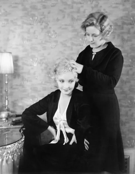 Μία γυναίκα, βοηθώντας την φίλη με τα μαλλιά της — Φωτογραφία Αρχείου