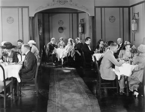 Grupo de personas sentadas en un restaurante cenando —  Fotos de Stock