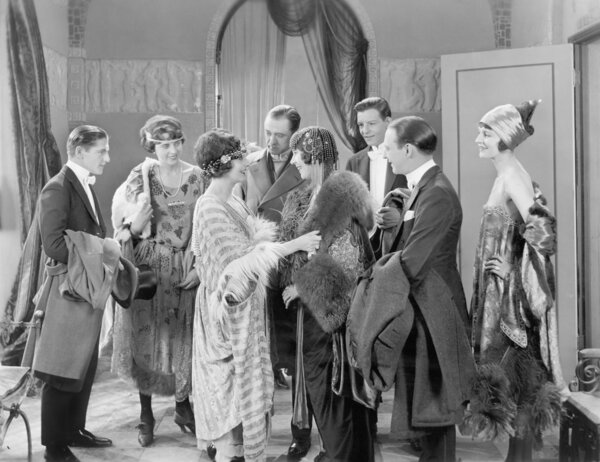 Elegant group of friends greeting each other in an apartment