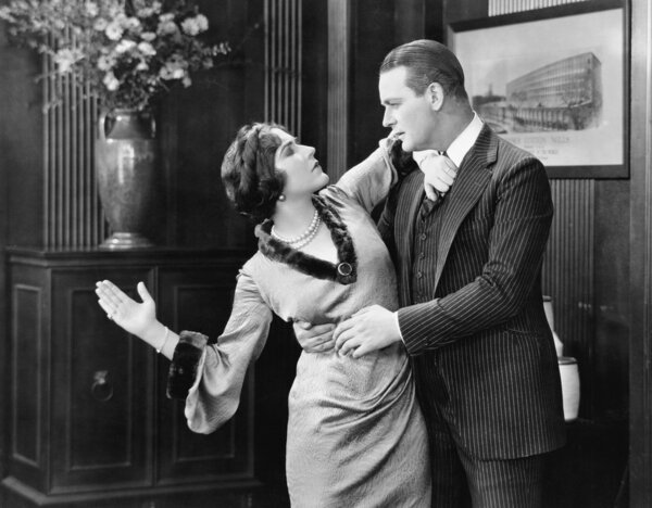 Woman about to slap a man in the face