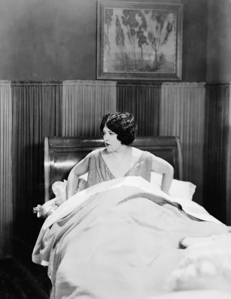 Portrait of woman in bed Stock Image