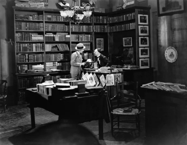 Customer and clerk in book shop — Stock Photo, Image