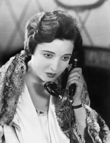 Young woman on the telephone Stock Picture