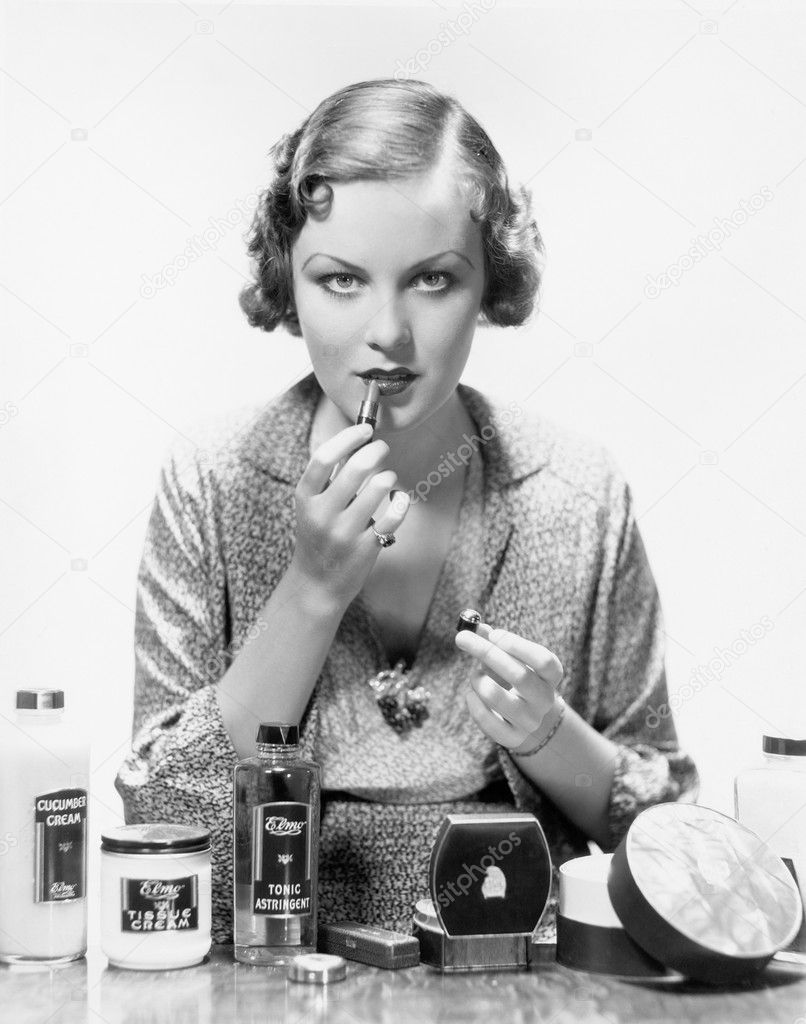 Woman applying cosmetics