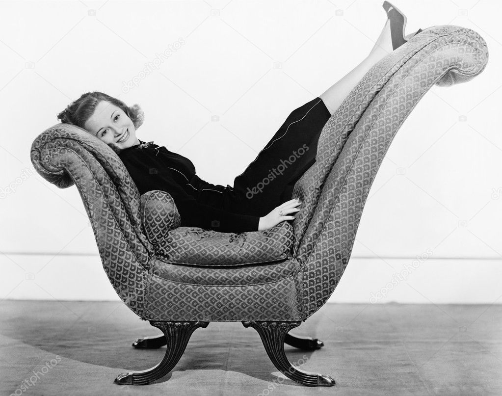 Portrait of woman on curved piece of furniture