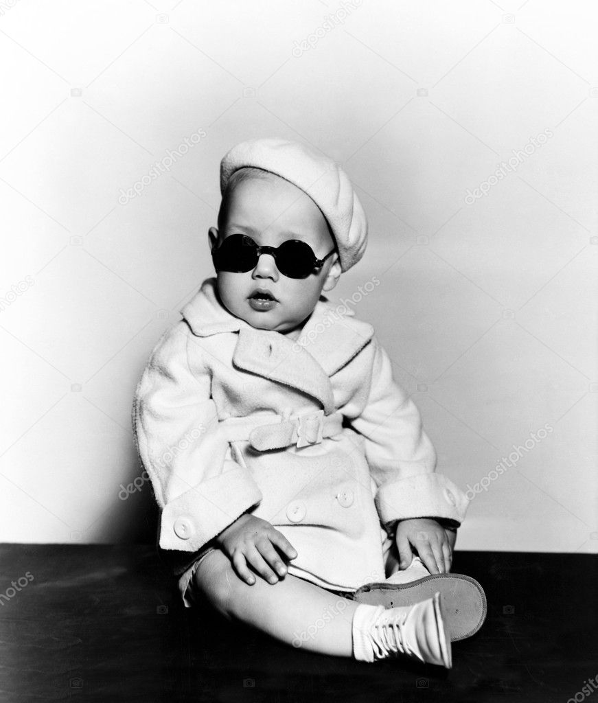 Portrait of baby wearing beret and sunglasses