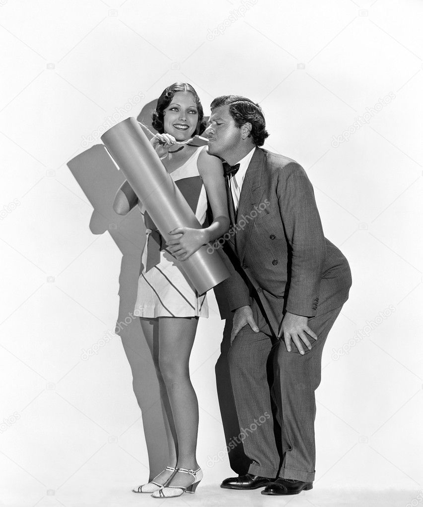 Playful man and woman lighting explosive with cigarette