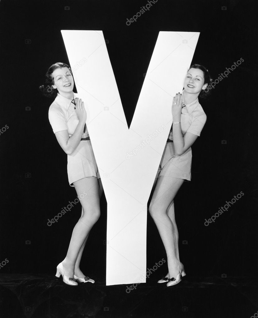 Women posing with huge letter Y