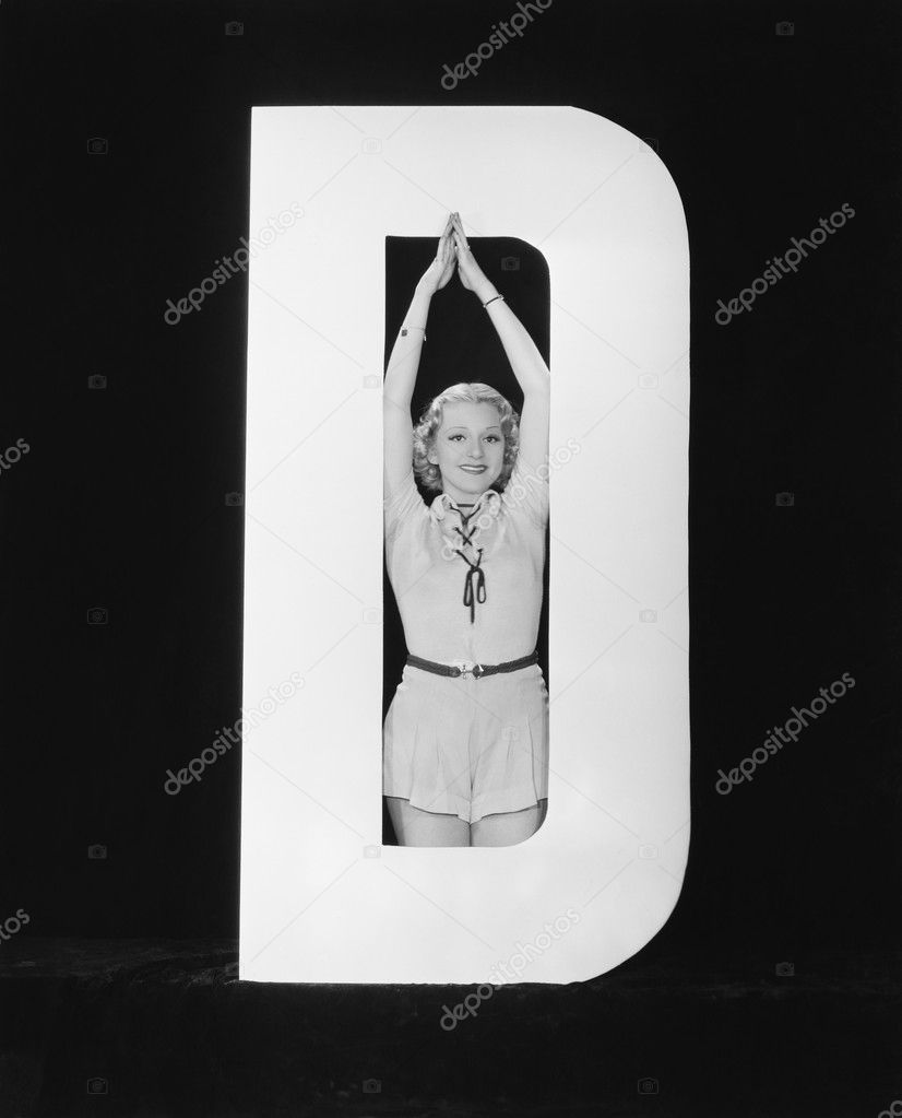 Woman posing in middle of letter D