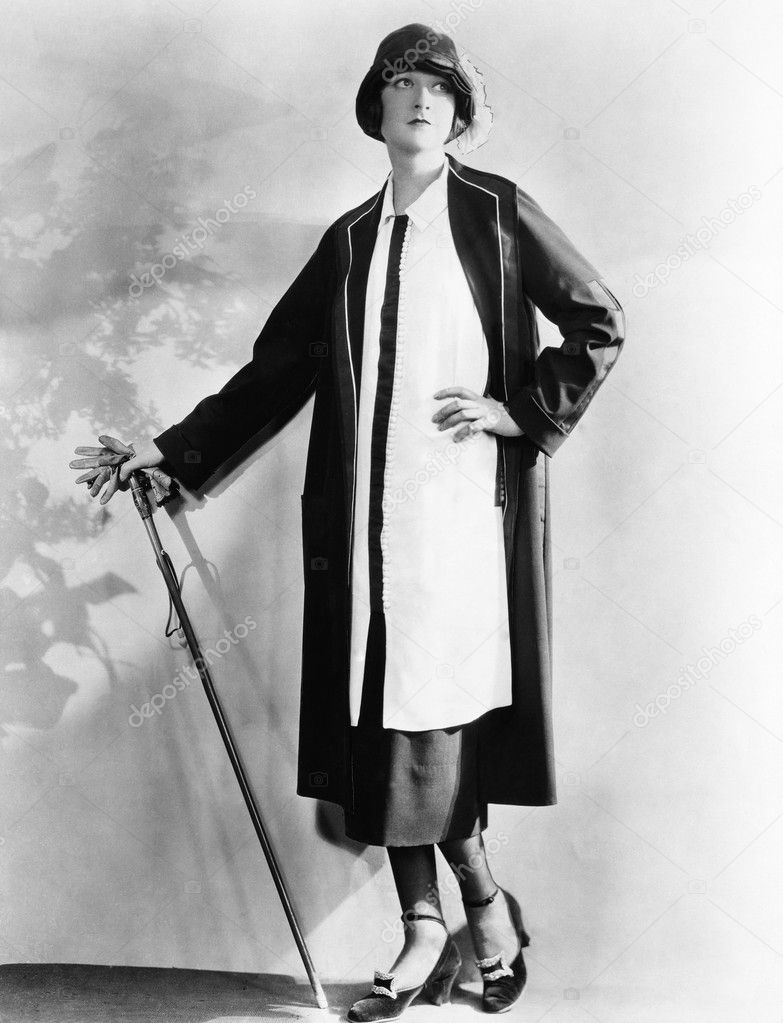 Portrait of woman with cane and gloves