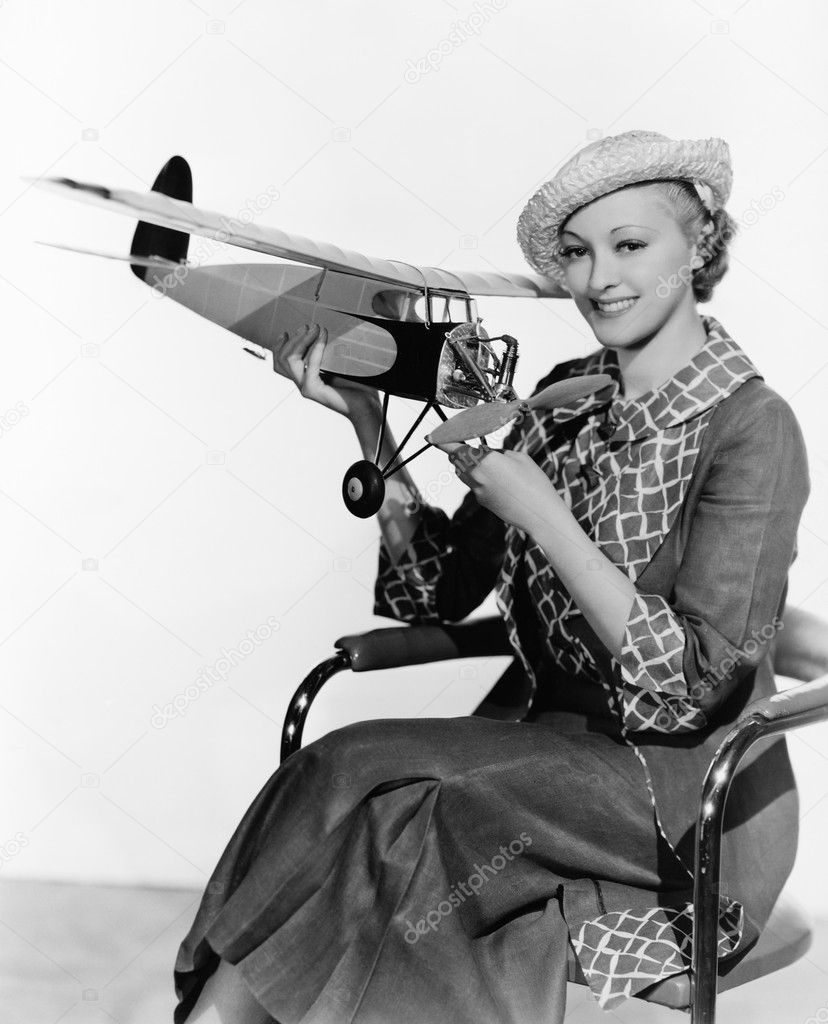 Woman holding model airplane
