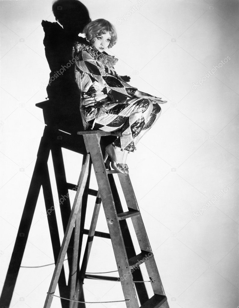 Profile of a young woman sitting on a ladder
