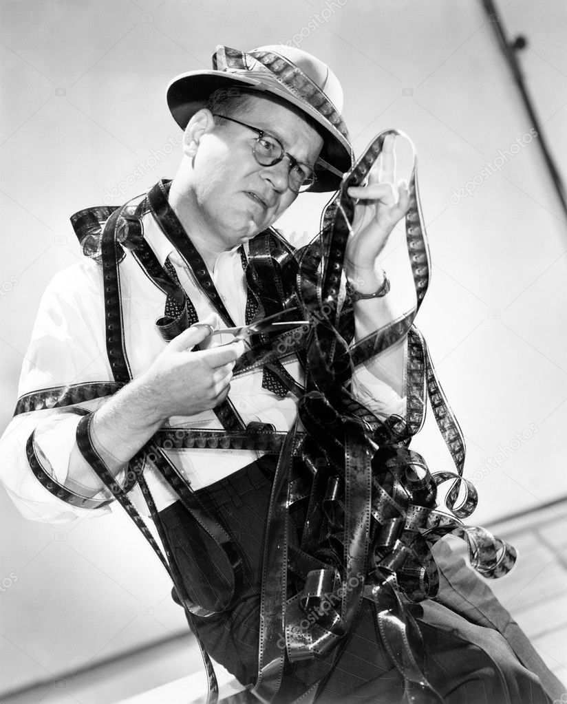 Man all tangled up with a film reel