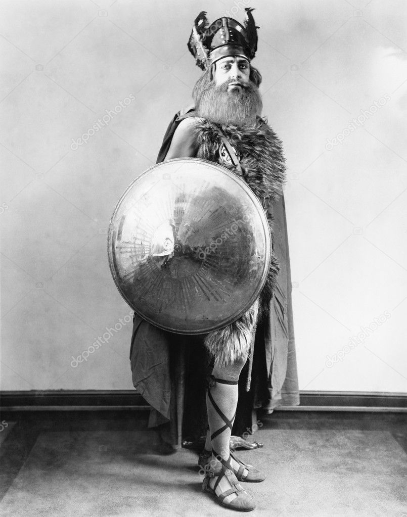 Portrait of a Viking warrior standing and holding a shield