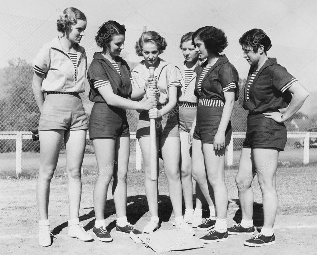 Woman holding a baseball bat and giving training to other women ⬇ Stock ...