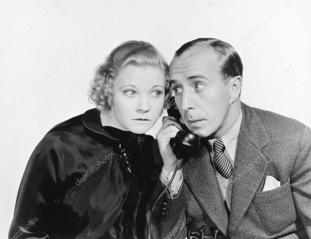 Man and a woman eavesdropping on the telephone