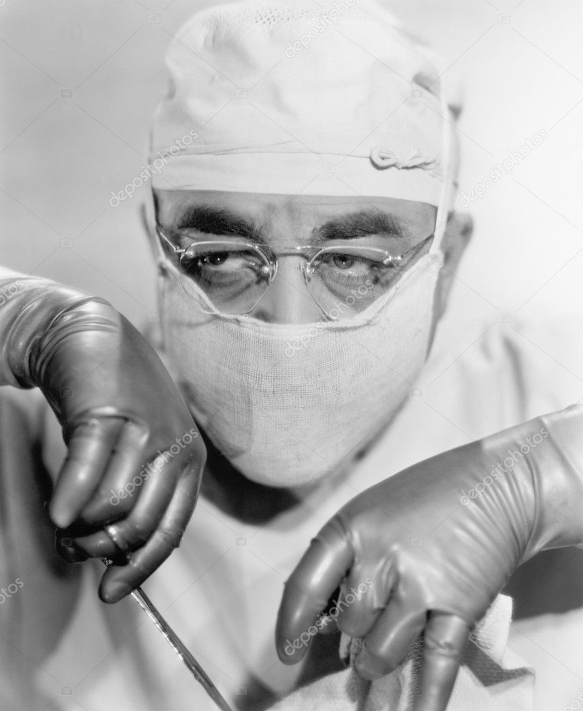 Surgeon in a surgical mask operating