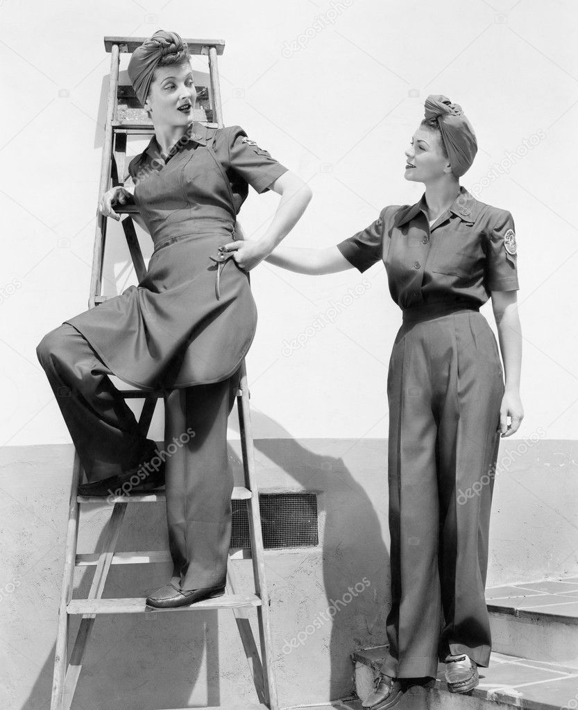 Two women standing together on a ladder and stairs