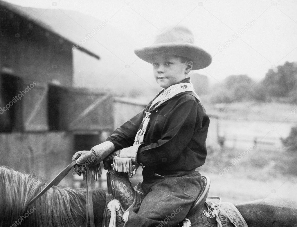 Boy in a cowboy hat on a horse