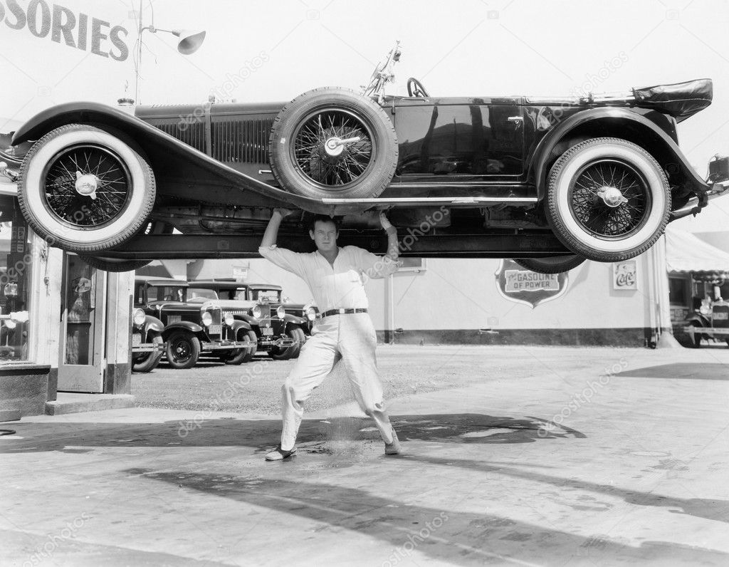 Strong man lifting a car over his head