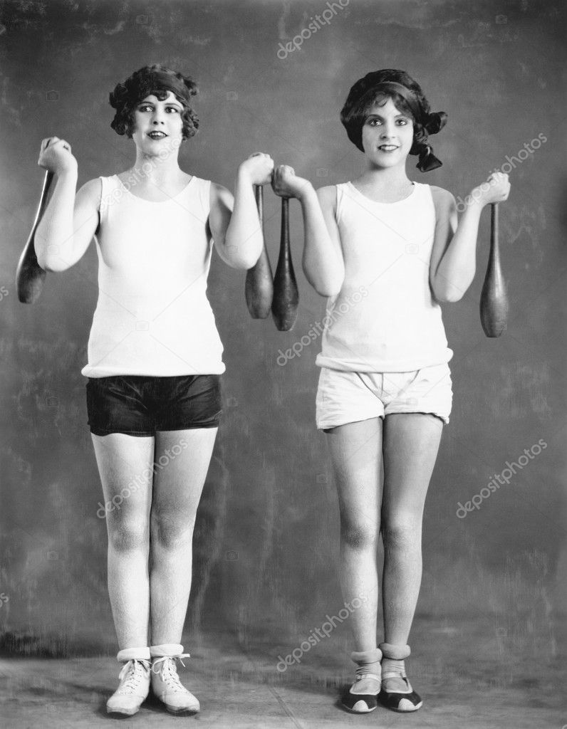 Two women exercising with juggling pins