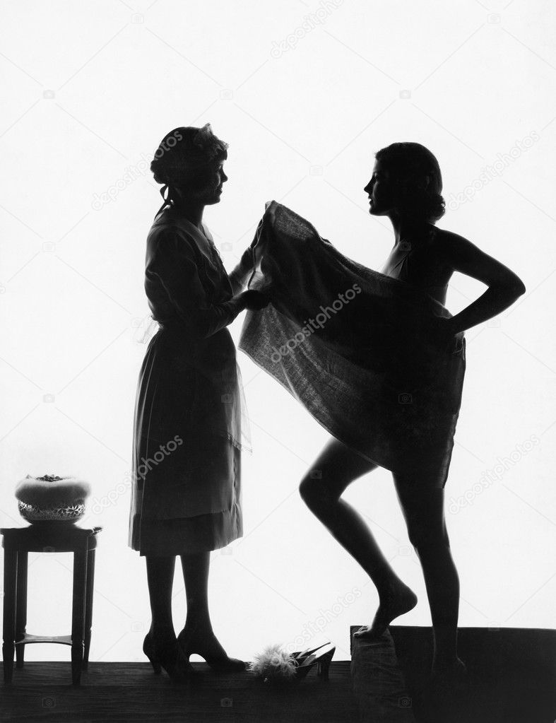 Silhouette of two women with a bath towel
