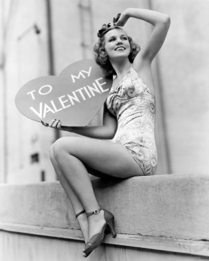 Woman holding a large valentine clipart