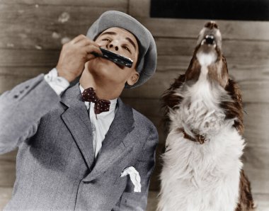 Man playing harmonica with howling dog clipart