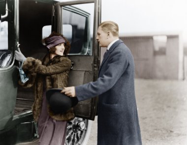 Profile of a man helping a young woman board a car clipart