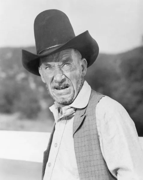 Stock image Man in a cowboy hat looking angry