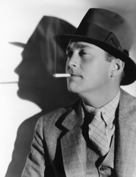 Portrait of a man in a fedora with a cigarette in his mouth