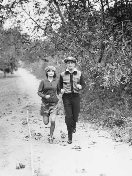 Couple jogging through the country side — Stock Photo, Image
