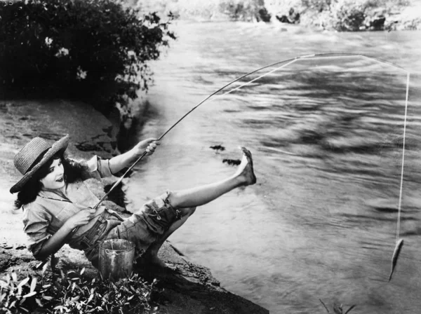 거꾸로 떨어지는 작은 물고기를 잡은 여자 — 스톡 사진