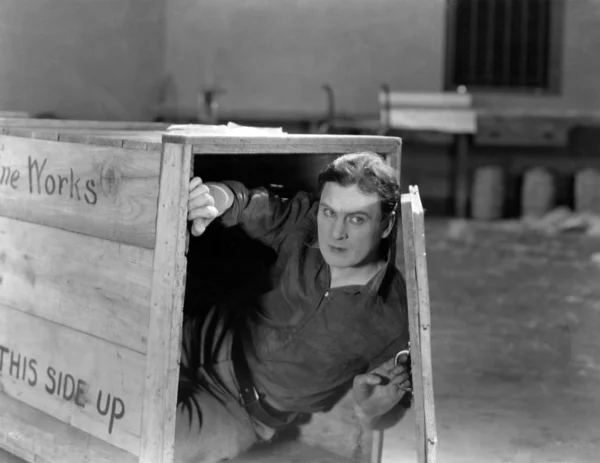 Man hiding in wooden crate — Stock Photo, Image