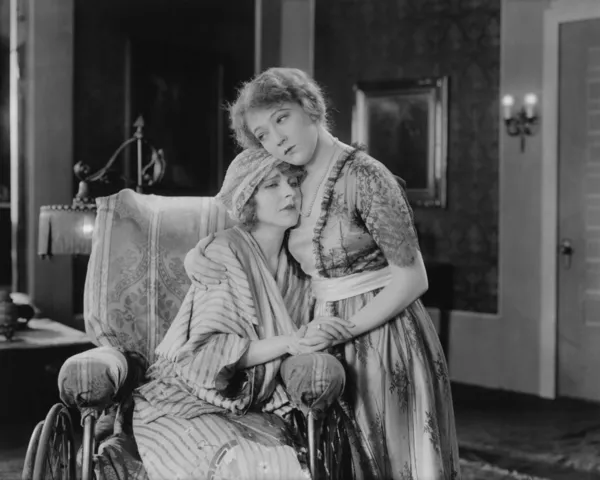 Jonge vrouw troostende haar vriend in rolstoel — Stockfoto