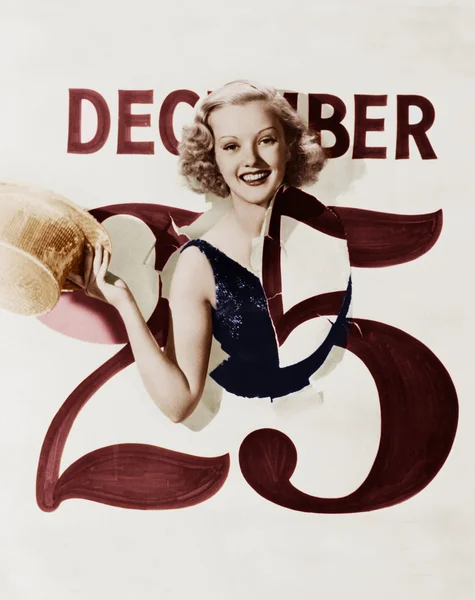 Woman bursting through calendar on Christmas day — Stock Photo, Image