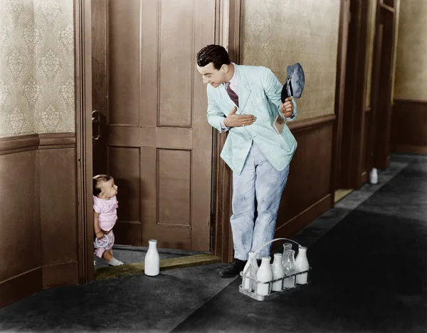 ドアに牛乳配達人挨拶赤ちゃん — ストック写真