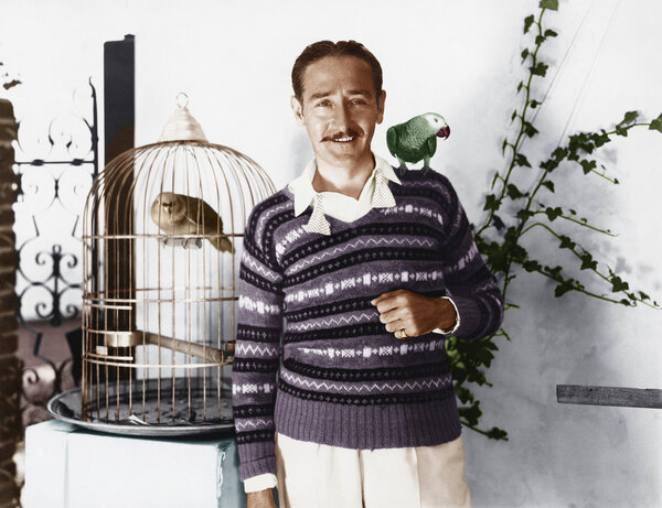 Man posing with pet birds