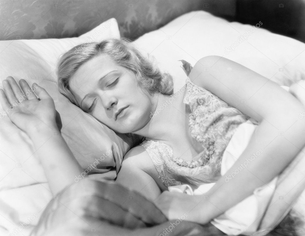 Young woman lying in her bed sleeping