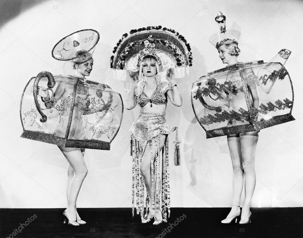 Three woman in ornate teapot costumes