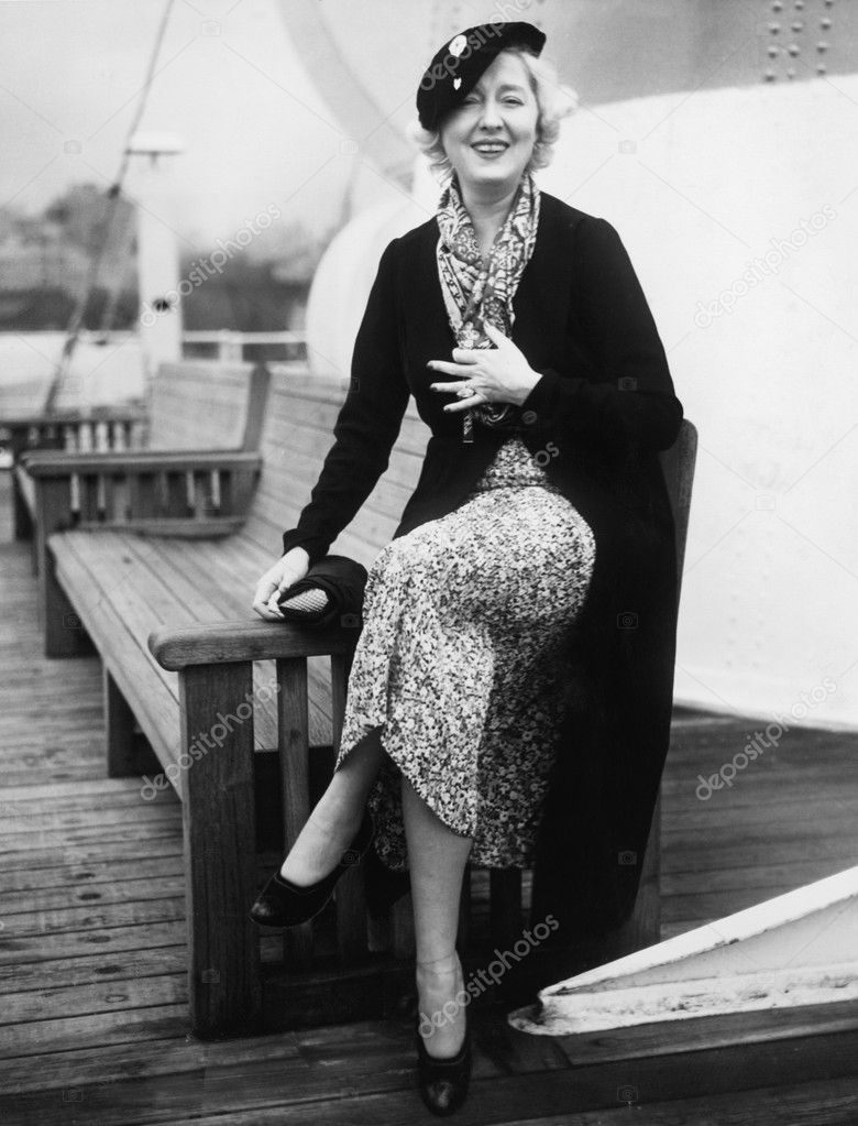 Woman sitting on the side of a bench on a ship