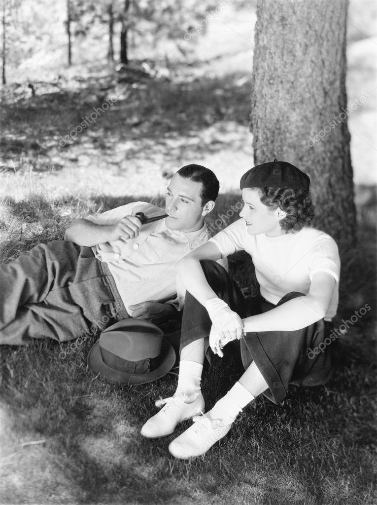 Couple sitting under a tree
