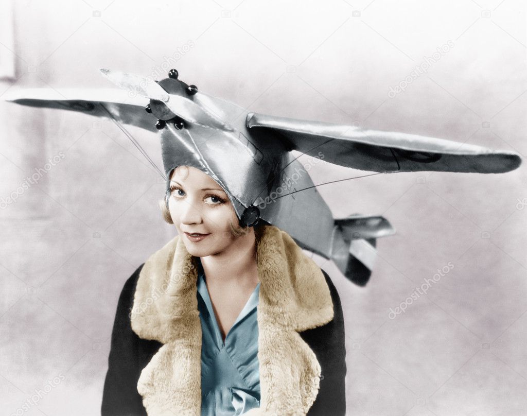 Portrait of a young woman wearing an airplane shaped cap