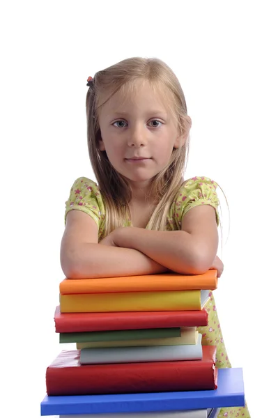 Malá holčička na stoh knih — Stock fotografie