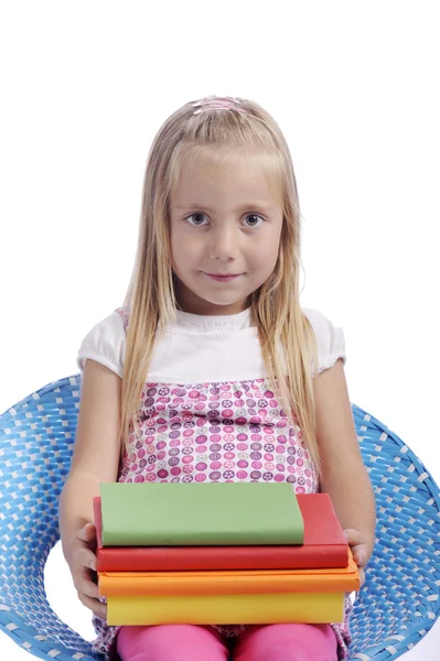 Bambina con pila di libri — Foto Stock