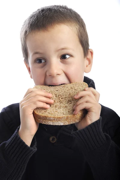 Menino comendo pão de sobrancelha — Fotografia de Stock